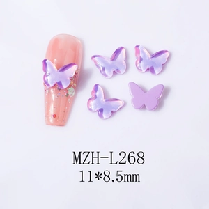 Macro detail of purple butterfly nail art charms 11x8.5mm showing aurora and matte finishes