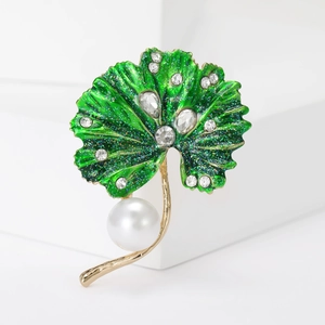 Elegant gold lotus leaf brooch with green enamel, crystals, and a large pearl drop