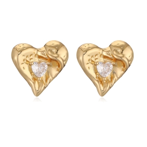 Gold lava texture heart earrings with zircon stones on a white background