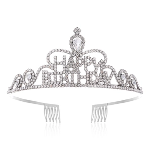 Macro detail of silver Happy Birthday crown with sparkling rhinestones and hair combs