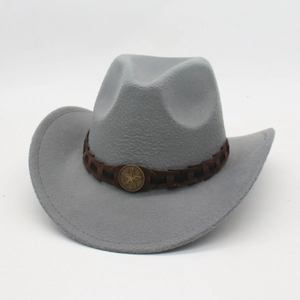 Macro detail of a gray felt cowboy hat with brown band and star metallic emblem