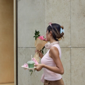 Light blue acetate bow hair claw clip styled on model in an outdoor street setting