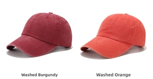 Flat lay of vintage washed cotton baseball caps in wine red and orange colors