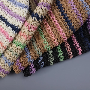 Detailed macro view of colorful striped hand-crocheted straw texture on a foldable bucket hat