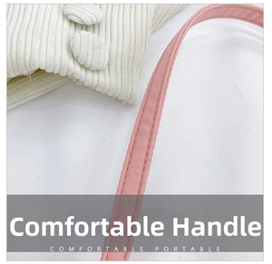 Close-up of pink woven handle and cream corduroy fabric with reinforced stitching