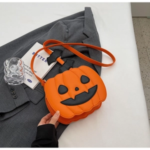 Detailed close-up of orange pumpkin bag with bat accents on a grey blazer