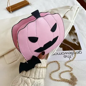 Pink pumpkin shaped crossbody bag with black bat charm and golden chain for Halloween