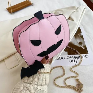 Pink pumpkin shaped crossbody bag with black bat charm and golden chain for Halloween