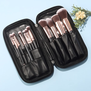 Detail of 12-piece black and rose gold makeup brush set with leather zipper storage case