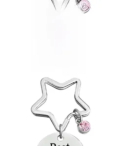 Macro shot of stainless steel round plate with pink rhinestone for Mother's Day keychain