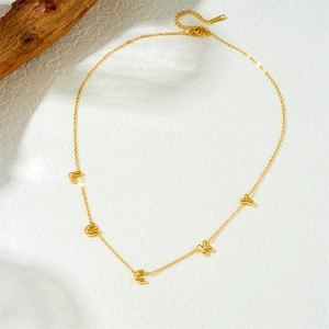 Detail of gold-plated chain necklace featuring LUCKY letter pendants with lobster clasp