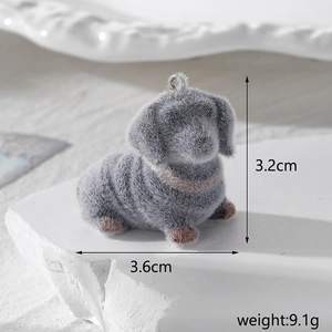 Macro detail of grey flocked dachshund charm with metal loop and 3.2cm height scale