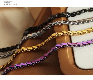 Close-up of titanium steel bracelets in black, silver, gold and iridescent purple finishes