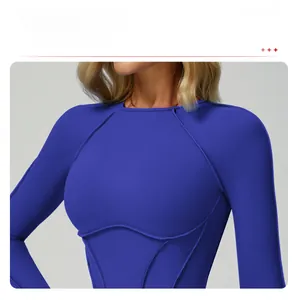 Detail of round neckline and contrast stitching on blue long sleeve fitness top