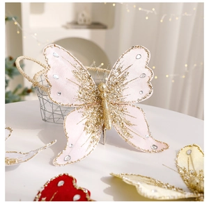 Close-up of pink fabric butterfly with gold sequins and rhinestones on metal clip
