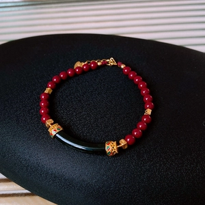 Macro detail of S925 silver cinnabar bracelet with Hetian jade and black cylinder bead