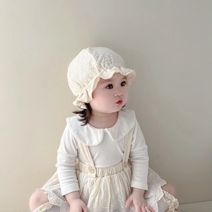 Close-up of baby lace bonnet with hollow embroidery and soft cotton texture details