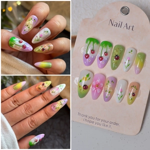 Detail of almond nails with 3D strawberry, ladybug motifs and realistic water droplets