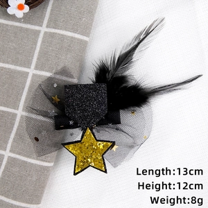 Detail view of mini graduation hat clip with sequins, black feathers and mesh veil