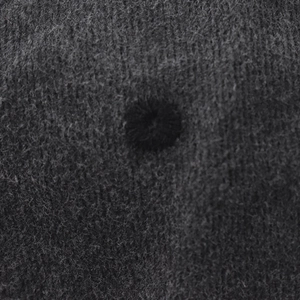 Close-up of charcoal grey washed denim fabric with detailed strawberry embroidery texture