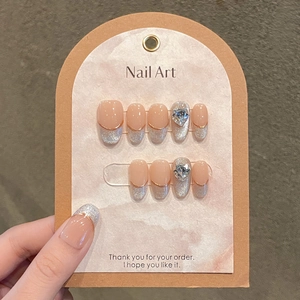 Cat eye press-on nails with silver glitter french tips and heart diamond accents