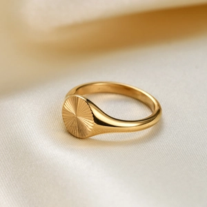 Gold stainless steel 9mm ring featuring an engraved sunburst pattern on silk background