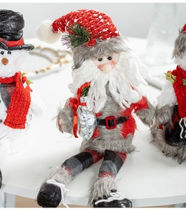 Detail of Nordic Christmas plush dolls with knitted textures and soft faux fur material