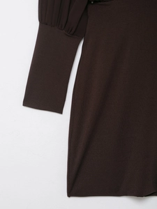 Detail of ribbed cuffs and accordion pleats on dark coffee long-sleeved dress