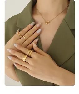 Close-up of interconnected gold circles pendant and textured rings set on model