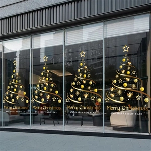 Golden Christmas tree window decals with stars and snowflakes on glass display