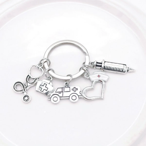 Detailed close-up of medical charms showing stethoscope, syringe, and ambulance