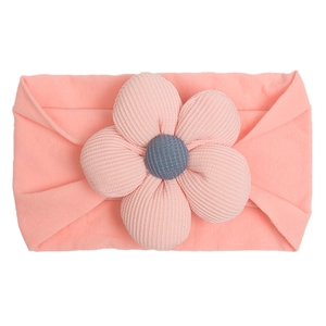Detailed shot of baby nylon headband with large ribbed fabric flower and button center