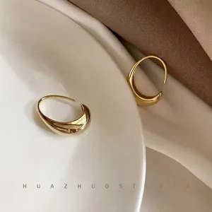 Elegant minimalist gold-tone C-shape hoop earrings with a high-polished finish for women