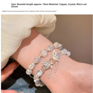 Detail of beaded bracelet set with crystal beads and micro-set butterfly pendant on wrist