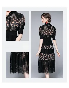 Detail of black lace dress with floral polka dots, sheer tulle fabric, and waist cinching