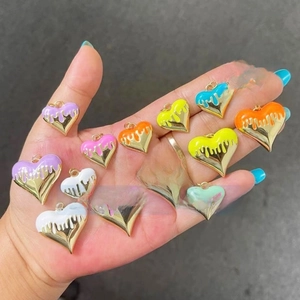 Colorful enamel heart pendants in various vibrant shades shown on a hand display