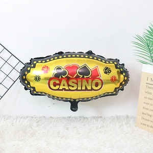 Detail of gold foil casino balloon featuring poker suits and dice for theme parties