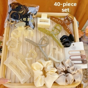 Detailed view of 40-piece hair accessory set featuring claw clips and elastic ties