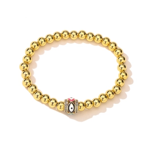 Close-up of 18K gold-plated beaded bracelet with colorful zircon evil eye charm