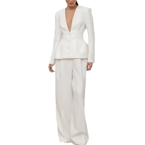 Women's white suit set featuring deep V-neck buttoned jacket and wide leg trousers