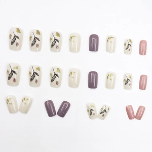 Purple and cream press-on nails set with ink-wash leaves and gold foil accents
