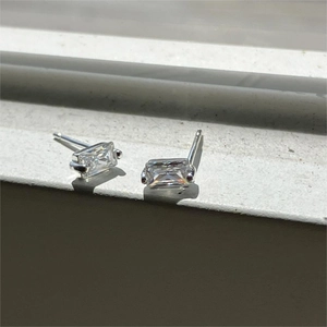 Minimalist silver 925 stud earrings with rectangular clear crystals in natural light