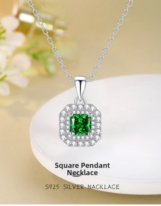Macro shot of S925 silver necklace with square emerald green zircon pendant and halo stones