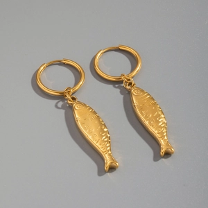 Close-up of golden stainless steel hoop earrings with small fish pendants in 18K gold finish