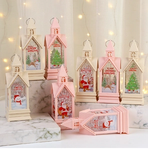 Detail of Christmas lantern decorations with Santa Claus and elk patterns on a marble surface
