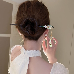 Classic Chinese wooden hair pin with light green jade-like disc and floral tassel detail