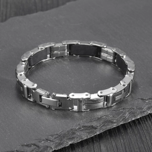 Detail of a men's stainless steel motorcycle chain bracelet with black silicone inlay