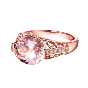 Macro shot of oval pink morganite ring with rose gold floral filigree and diamonds