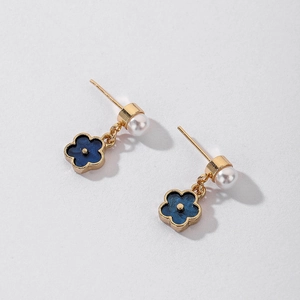 Detail of vintage blue flower earrings with pearl studs and golden chain links