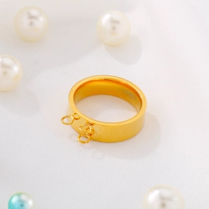Polished gold stainless steel ring with triple hanging loops on textured fabric
